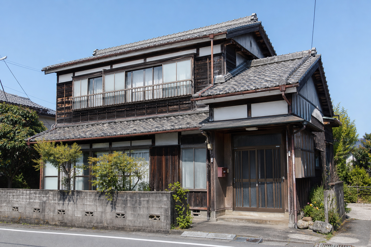An older Japanese wooden house on a quiet street in daylight